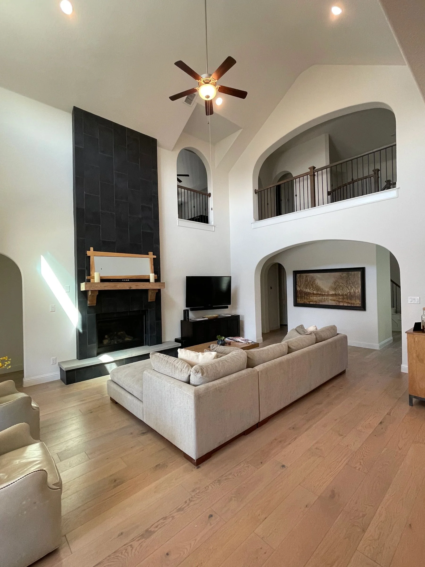 Finished living room with painted walls, trim, and fireplace surround